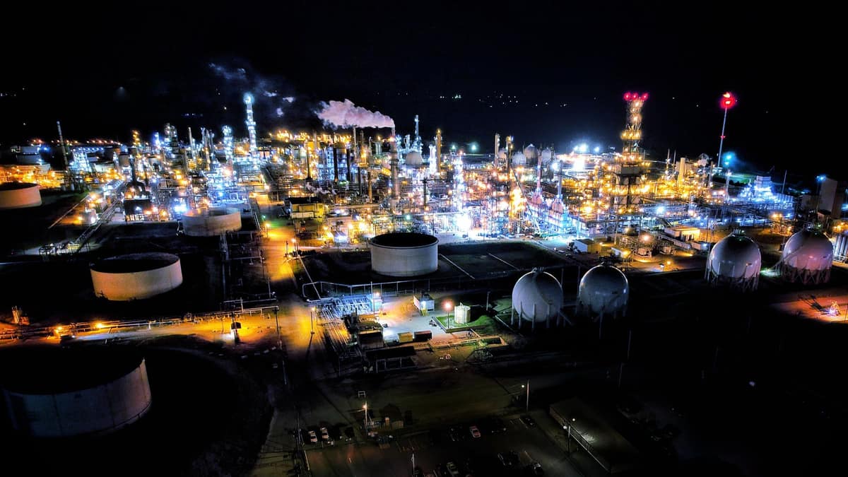 A refinery lit up at night during a shutdown window